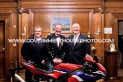 BEM investiture at Government House for Richard ‘Milky’ Quayle at Government House, Isle of Man - pictured with surprise guest John McGuinness and Lieutenant Governor Sir John Lorimer